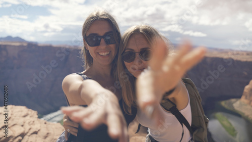 Happy people celebrating cheering in Grand Canyon. Young multiethnic couple on hiking travel excited and elated in Grand Canyon, south rim, Arizona, USA. Asian woman and Caucasian man.
