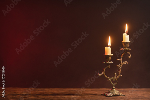 Fotografía A burning candle on the table front view background with copy space