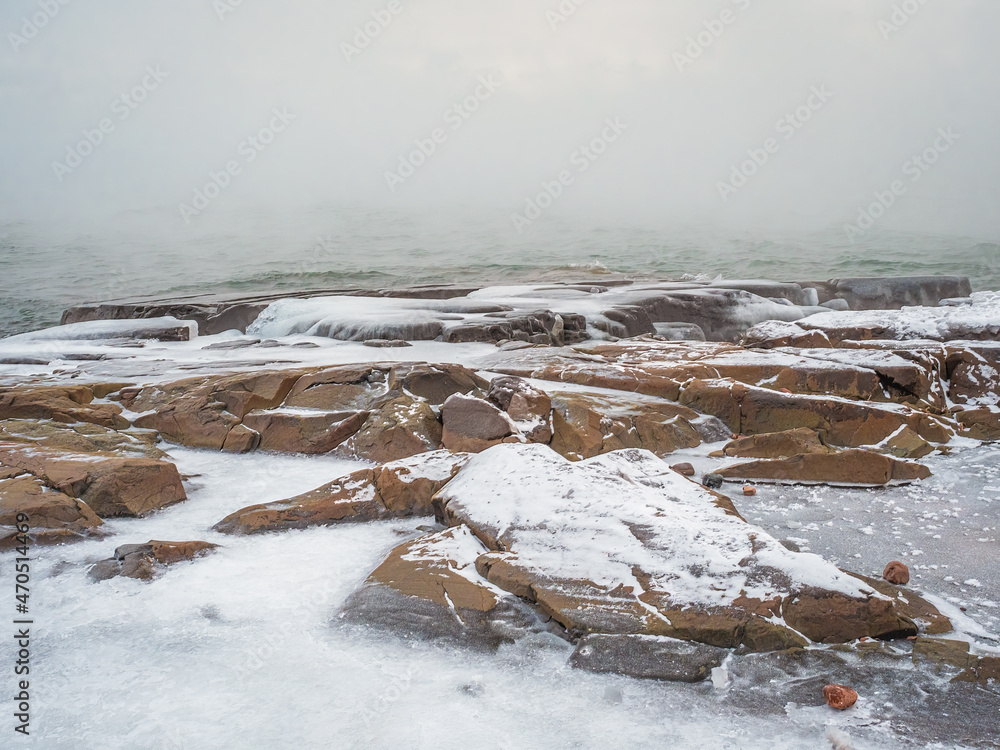 Freezing winter shoreline with rocks and icy waves. Freezing winter shoreline with rocks and icy waves.