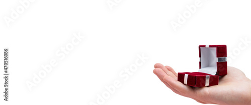 Man's hand holds opened red box isolated on white background. Wedding concept. Valentine's day. Text space