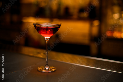 great view of beautiful glass on long leg with bright red drink on the table