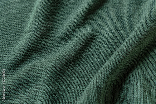 abstract background of light green knit fabric texture close up