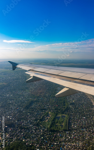 View from the airplane window during taking off on a clear summer morning. Yekaterinburg, Russia photo