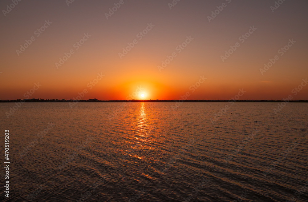 The sun goes down over a lake