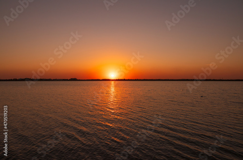 The sun goes down over a lake