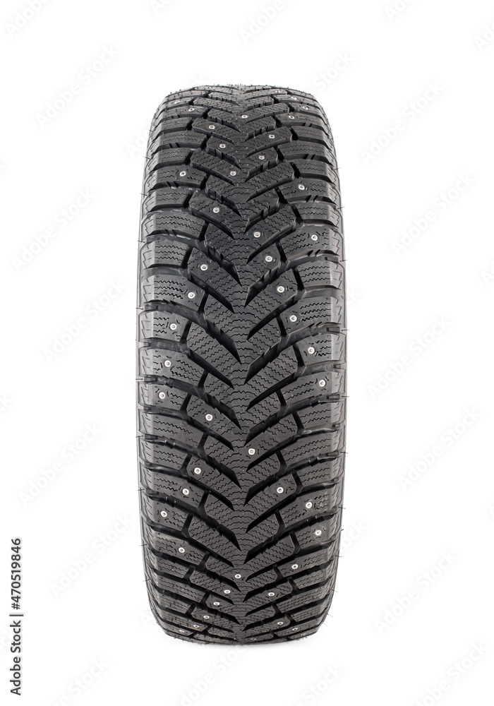 One new winter tire with spikes on a white background close-up. Isolated on white background One new winter tire with spikes on a white background close-up. Isolated on white background