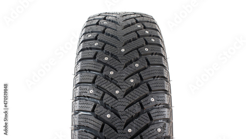 One new winter tire with spikes on a white background close-up. Isolated on white background