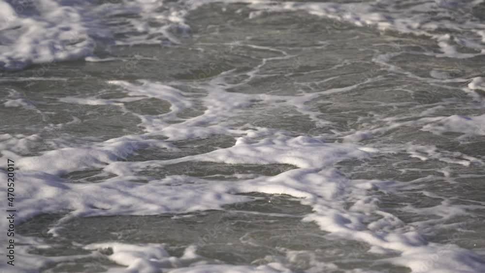 Foaming waves break on the shore Foaming waves break on the shore