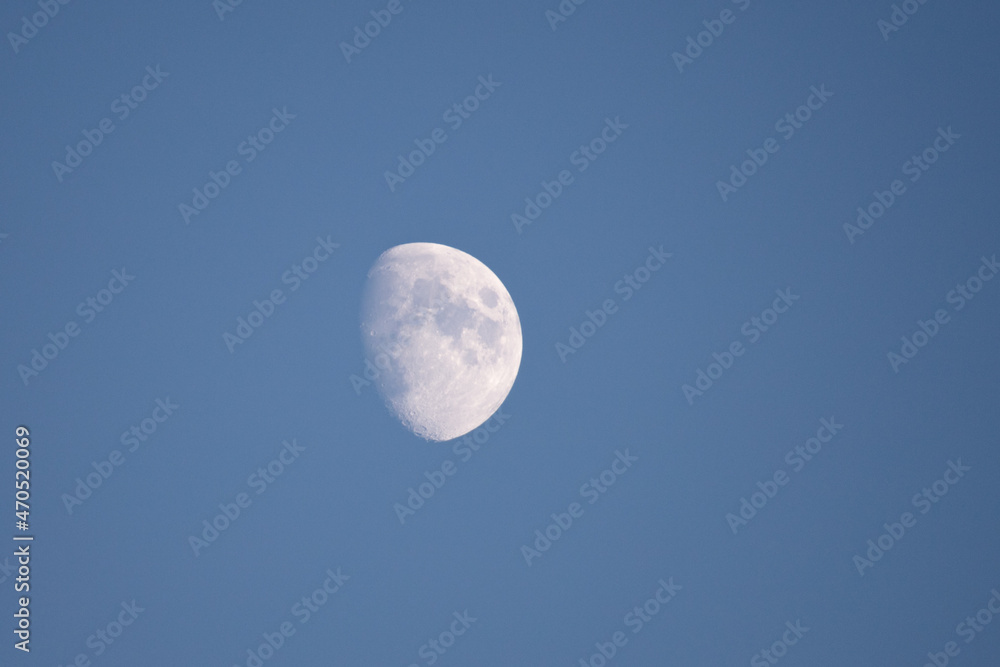 Closeup moon on daily sky. Waxing gibbous lunar phase Closeup moon on daily sky. Waxing gibbous lunar phase