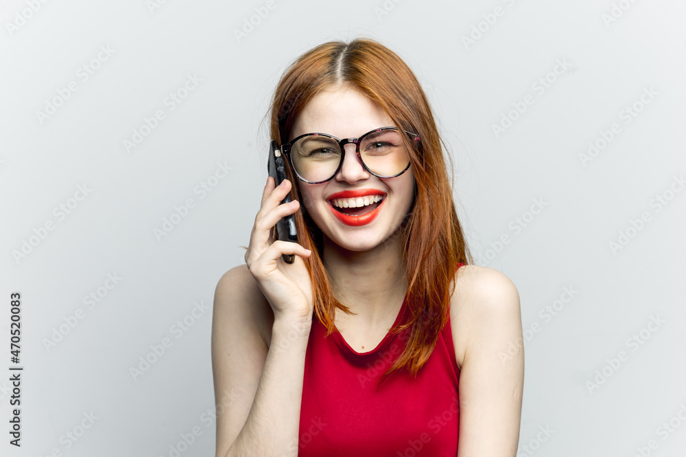 emotional red-haired woman with a phone in her hands communicating gadget emotional red-haired woman with a phone in her hands communicating gadget
