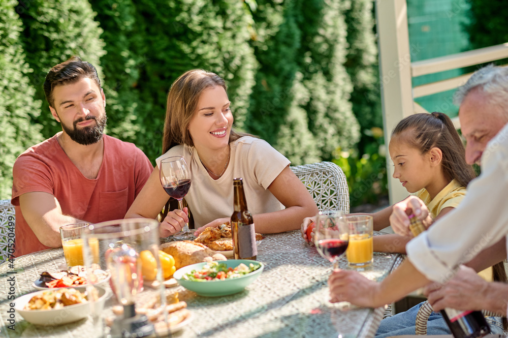 Cute family spending time in the back yard and looking happy Cute family spending time in the back yard and looking happy