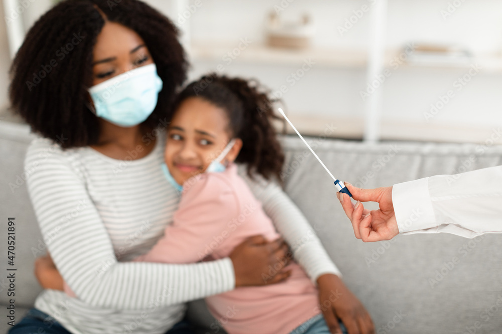 Doctor taking PCR test sample from afraid black teen girl Doctor taking PCR test sample from afraid black teen girl