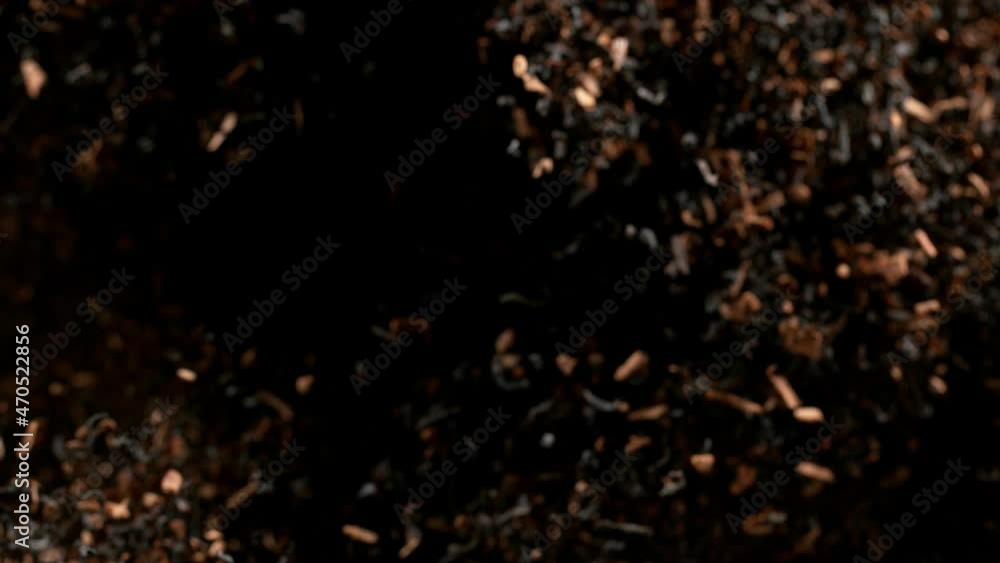 Super slow motion of dry tea leaves flying in the air on a black background, 1000 fps. Super slow motion of dry tea leaves flying in the air on a black background, 1000 fps.