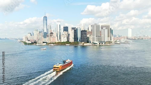 Staten Island Ferry to New York City. South ferry terminal. Aerial Manhattan drone skyscrapers. NYC holidays tourists visit USA, American urban destination. 