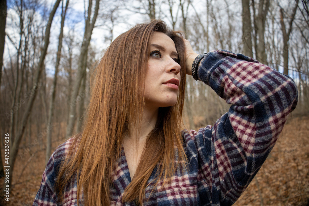 Beautiful girl in the woods near the trees