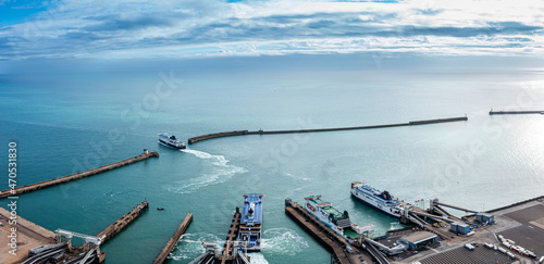 Aerial view of the Dover harbor with many ferries and cruise ships entering and exiting Dover, UK.
