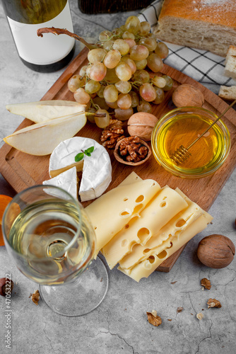 Still life of white wine, cheese and fruits