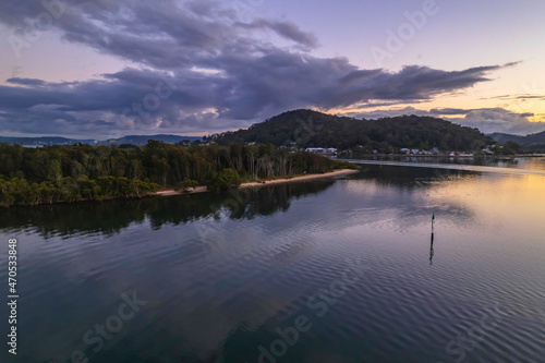 Aerial sunrise over the bay with clouds and reflections