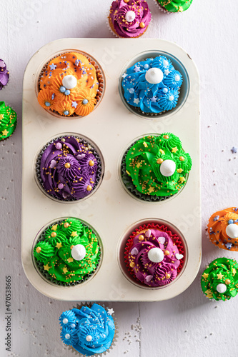 Sweet multicolored cupcakes made of cream for fat thursday. photo