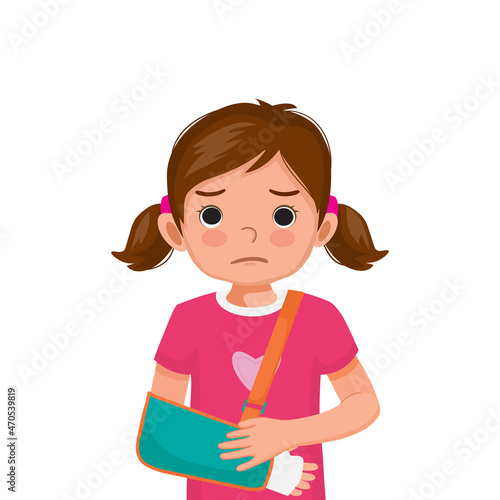 Little girl with broken arm in bandage wearing arm sling after accident.

