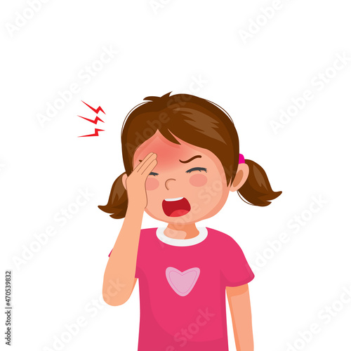 Little girl suffering from headache or migraine touching her forehead.