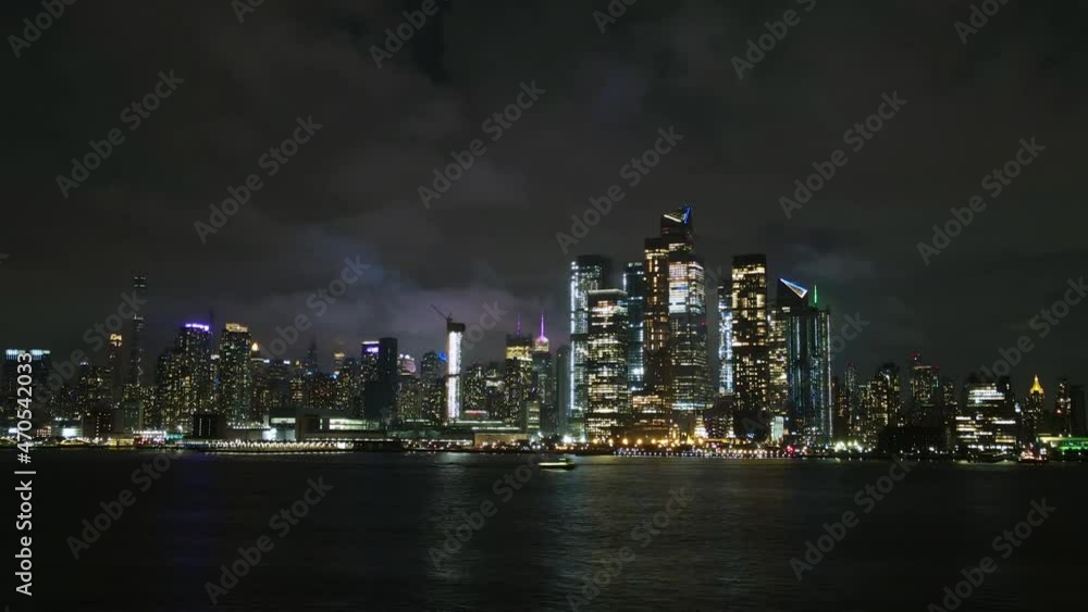 Hyper lapse aerial view of the Midtown cityscape with lights and moving clouds, in Manhattan, New York Hyper lapse aerial view of the Midtown cityscape with lights and moving clouds, in Manhattan, New York