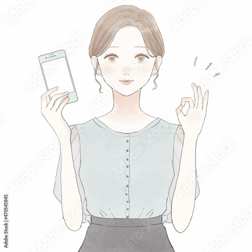 スマホを持ってOKサインを出している女性