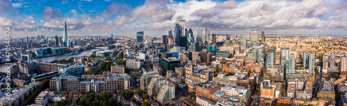 Aerial panoramic scene of the London city financial district with many iconic skyscrapers near river Thames.