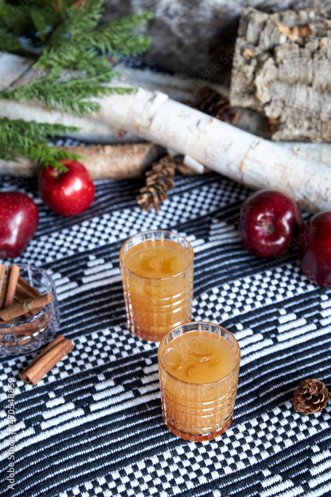 Apple spiced cider served on ice with apple and cinnamon Apple spiced cider served on ice with apple and cinnamon