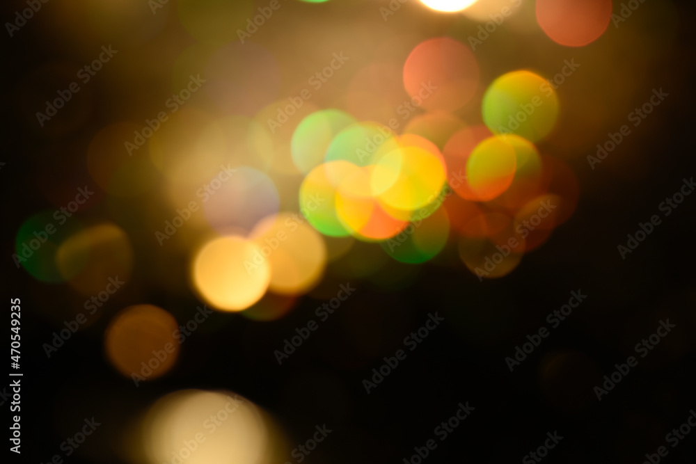Multicolored glitter lights background. Blurry rainbow defocused circles. Abstract illuminated backdrop or overlay.