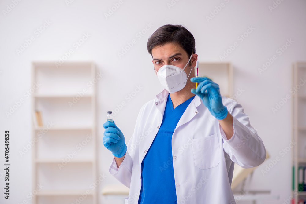 Young male doctor in vaccination concept Young male doctor in vaccination concept