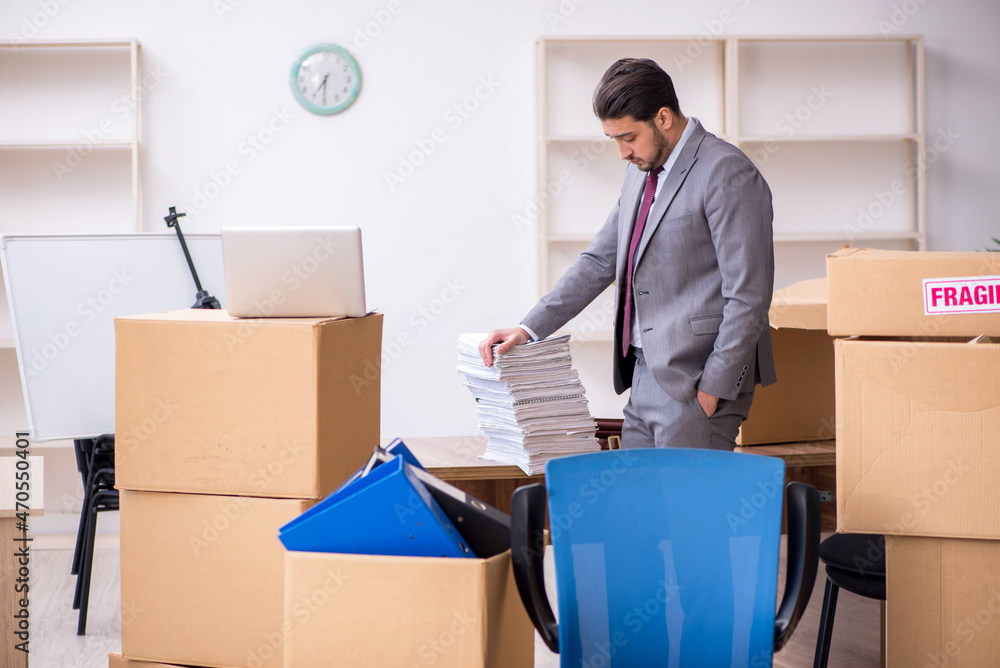 Young male employee in relocation concept Young male employee in relocation concept