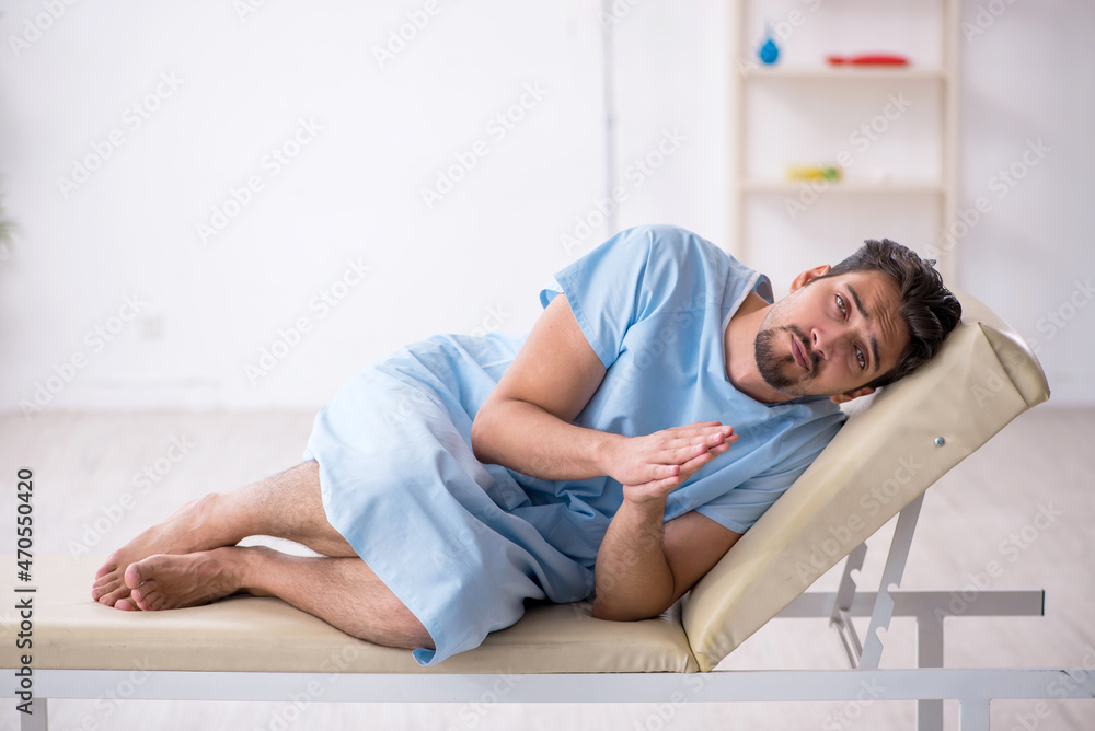 Young male patient waiting for doctor at the hospital