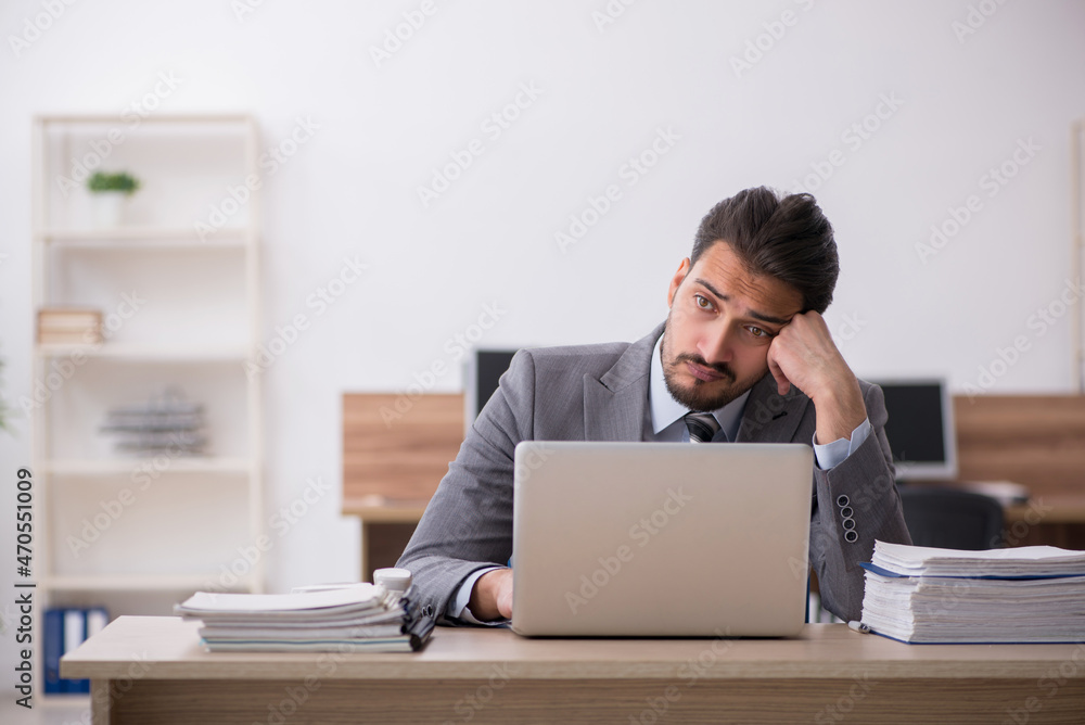 Young male employee working in the office Young male employee working in the office