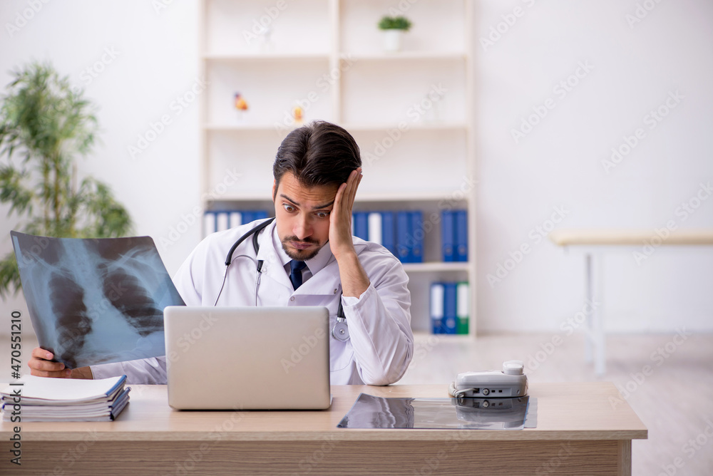 Young male doctor radiologist working in the clinic Young male doctor radiologist working in the clinic