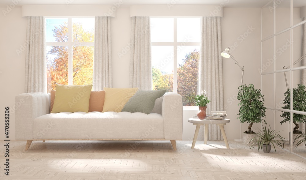 Fototapeta premium Stylish room in white color with sofa and autumn landscape in window. Scandinavian interior design. 3D illustration