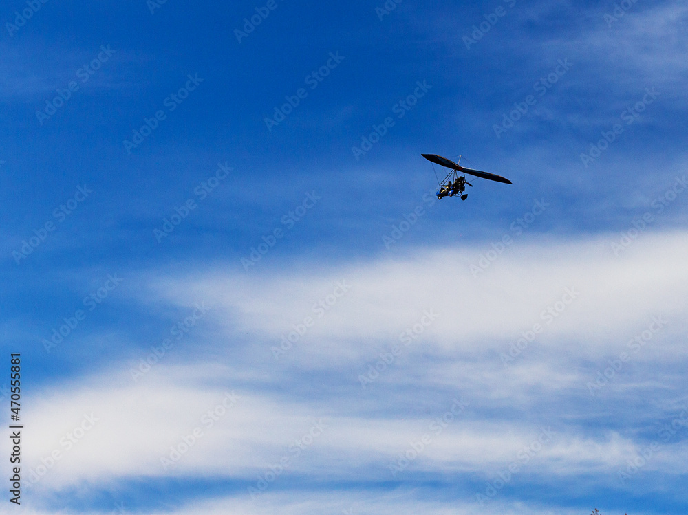 Flying a motorized hang glider on an autumn sunny day. Flying a motorized hang glider on an autumn sunny day.
