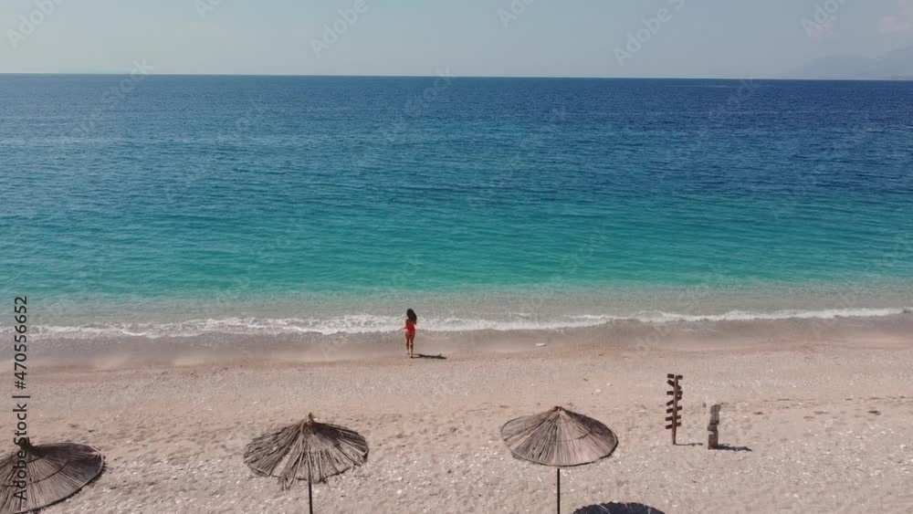 Drone air. Woman walking on beach.
Albania. Ionic Sea, Turquoise Water. Albanian Tourism. Drone air. Woman walking on beach.
Albania. Ionic Sea, Turquoise Water. Albanian Tourism.