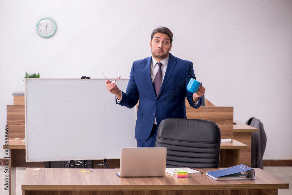 Young handsome employer in teleconference concept Young handsome employer in teleconference concept