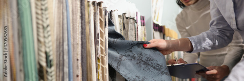 Seller and buyer choose fabrics for curtains in showroom