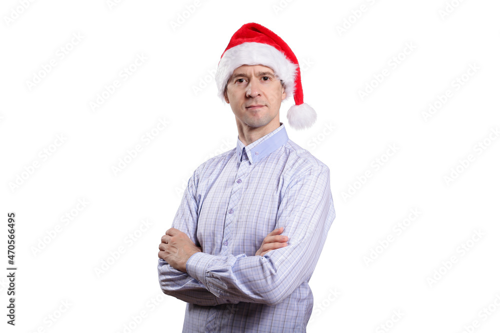 An adult confident man looks into the camera, crosses his arms on his chest, dresses in everyday clothes, a light plaid shirt, a New Year's cap. Isolated An adult confident man looks into the camera, crosses his arms on his chest, dresses in everyday clothes, a light plaid shirt, a New Year's cap. Isolated
