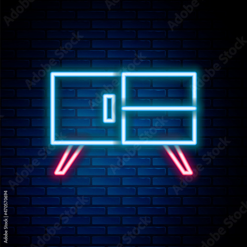 Glowing neon line Chest of drawers icon isolated on brick wall background. Colorful outline concept. Vector