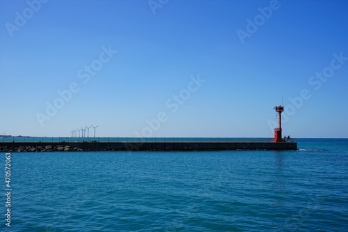 a beautiful seascape with a lighthouse