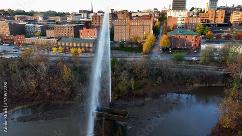 Water fountain in James River, downtown Lynchburg, Virginia, USA. Beautiful slow-mo aerial in autumn golden hour light. photo