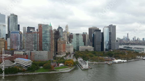Aerial view of tall office buildings on the riverfront of Manhattan, New York, USA - tracking, drone shot