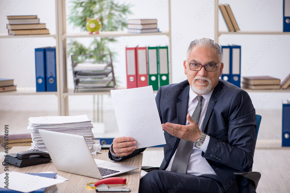 Old male employee and too much work in the office Old male employee and too much work in the office
