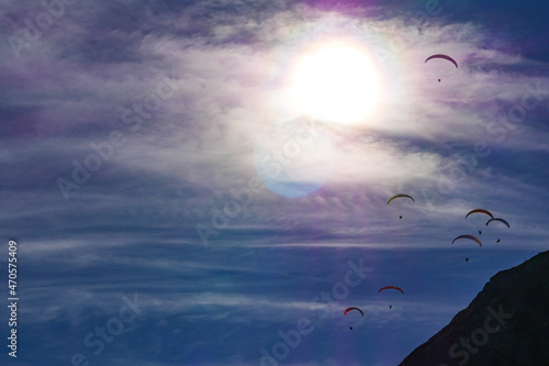 Paraglider flying over mountains in summer day in front of the mountain, High quality photo