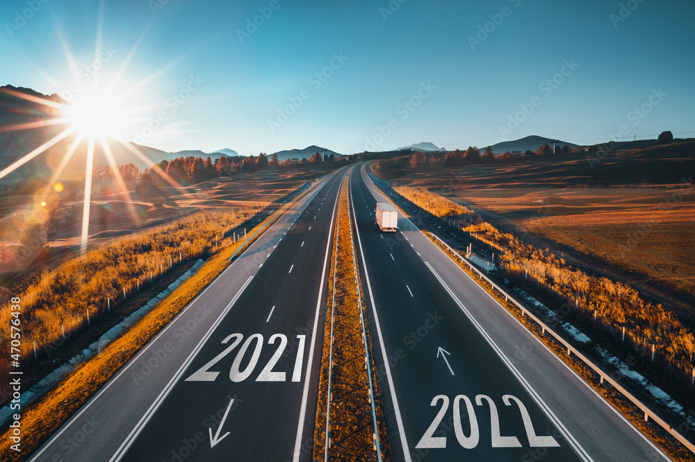 Driving on open road at beautiful sunny day to new year 2022. Aerial view - obrazy, fototapety, plakaty 