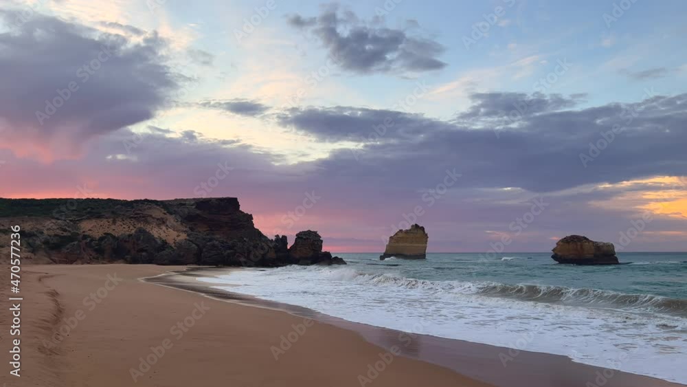 Looking along coast at beautiful coloured sky with rock formations at The 12 Apostles Looking along coast at beautiful coloured sky with rock formations at The 12 Apostles