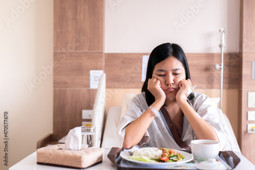 Asian patient women feeling unhappy and bored meal,Loss of appetite,Bored with food © gballgiggs